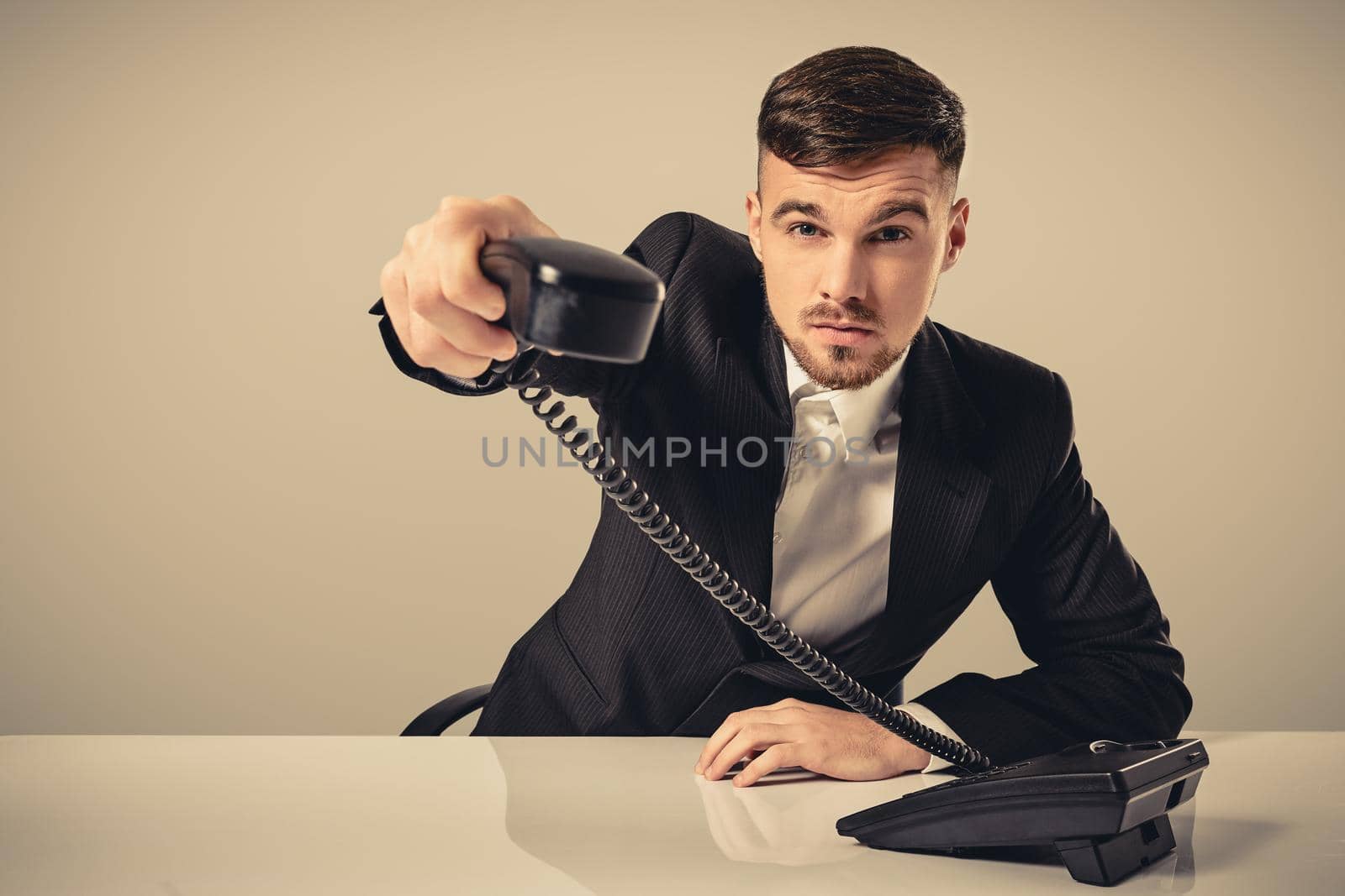Portrait of attractive businessman holding telephone in his hand by nazarovsergey