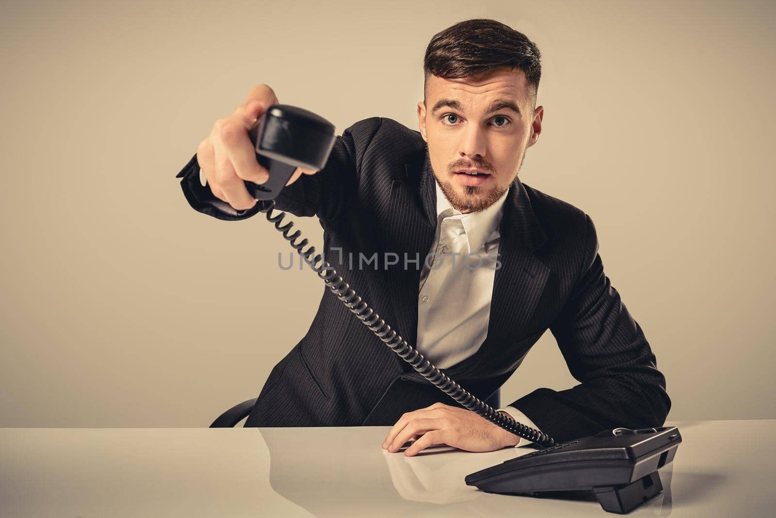 Portrait of attractive businessman holding telephone in his hand by nazarovsergey