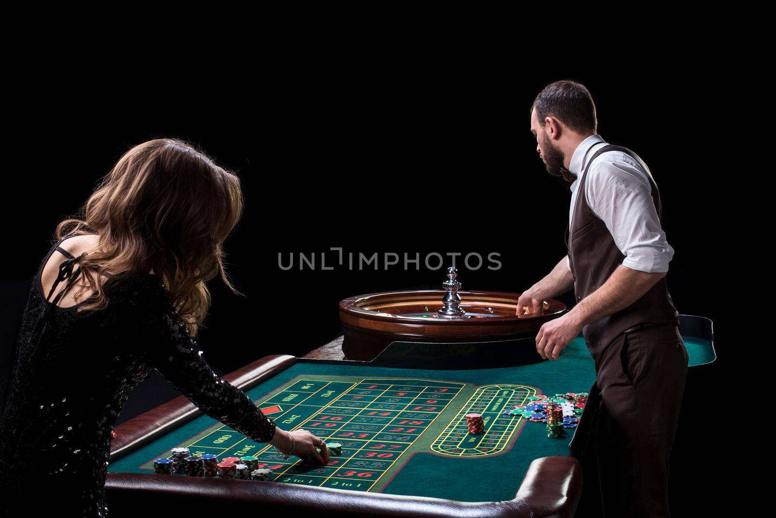 Croupier and woman player at a table in a casino. Picture of a c by nazarovsergey