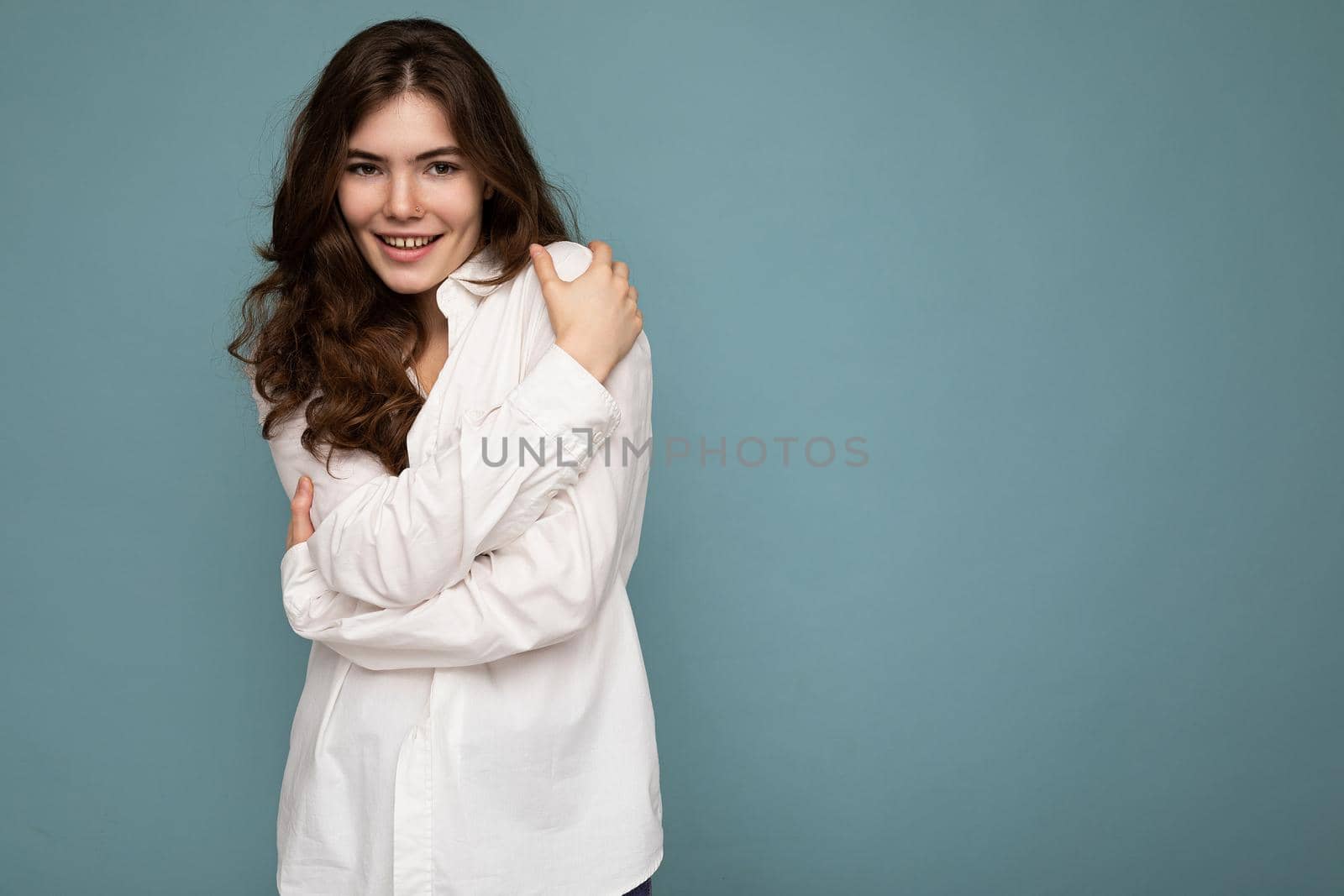 Photo of cute nice winsome positive adult woman wearing casual outfit isolated on background wall with copy space.