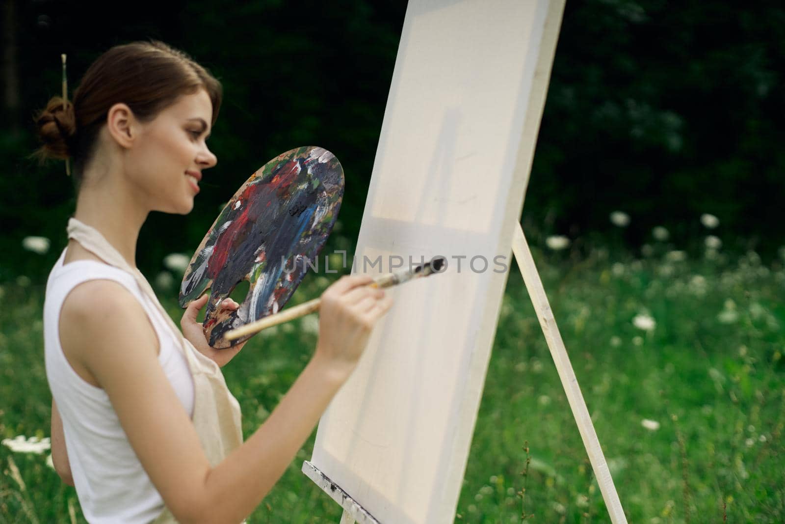 woman outdoors paint a picture landscape hobby creative. High quality photo