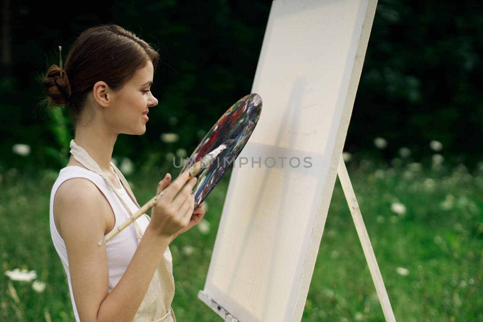 woman outdoors paint a picture landscape hobby creative. High quality photo