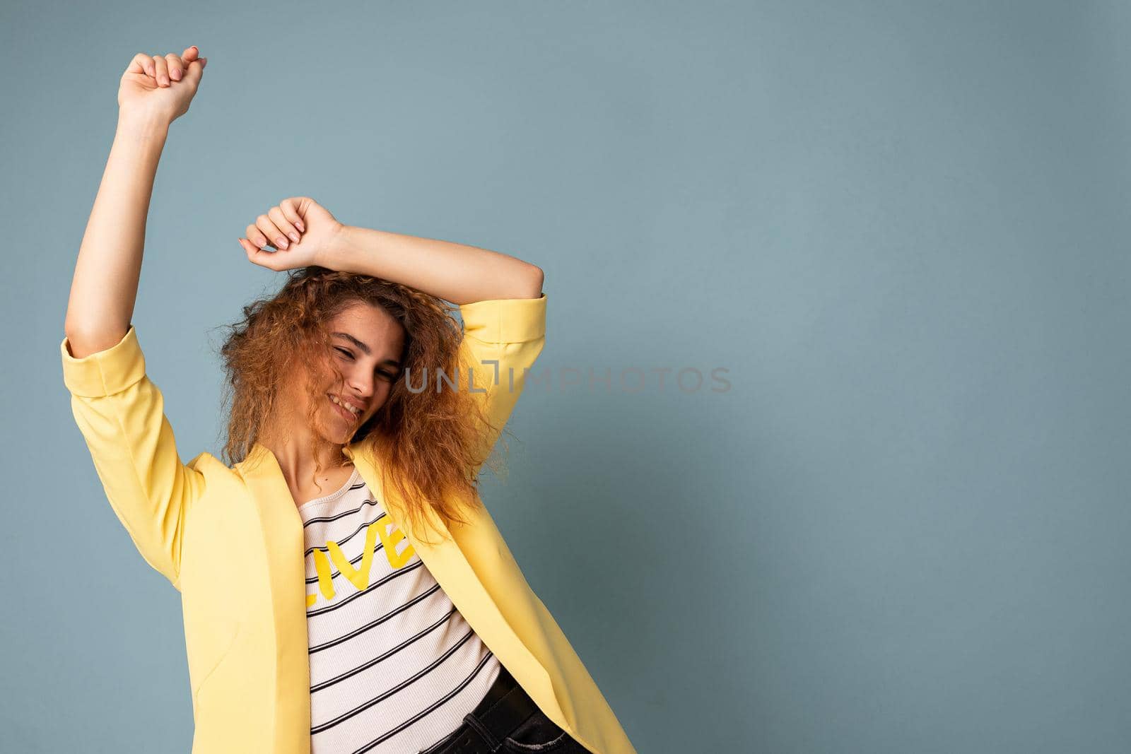 Photo of attractive cute happy emotional young woman poising isolated on background wall with free space wearing trendy casual clothes.