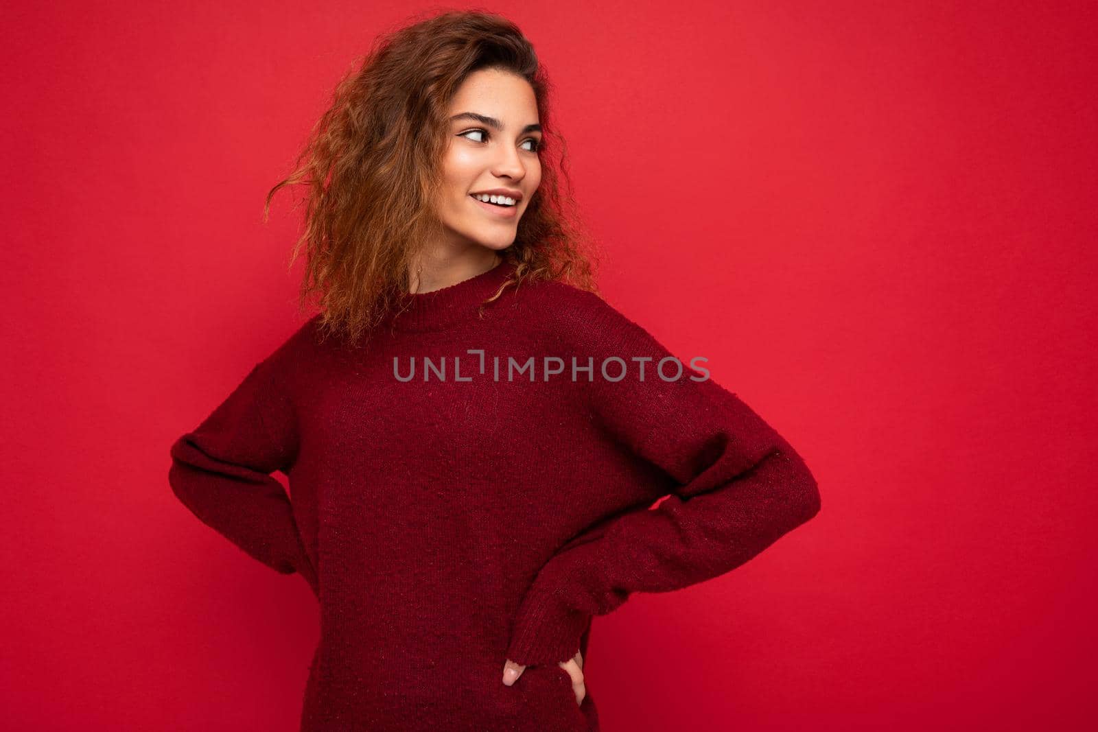 Shot of attractive happy smiling young woman wearing casual outfit standing isolated over colourful background with empty space looking to the side by TRMK