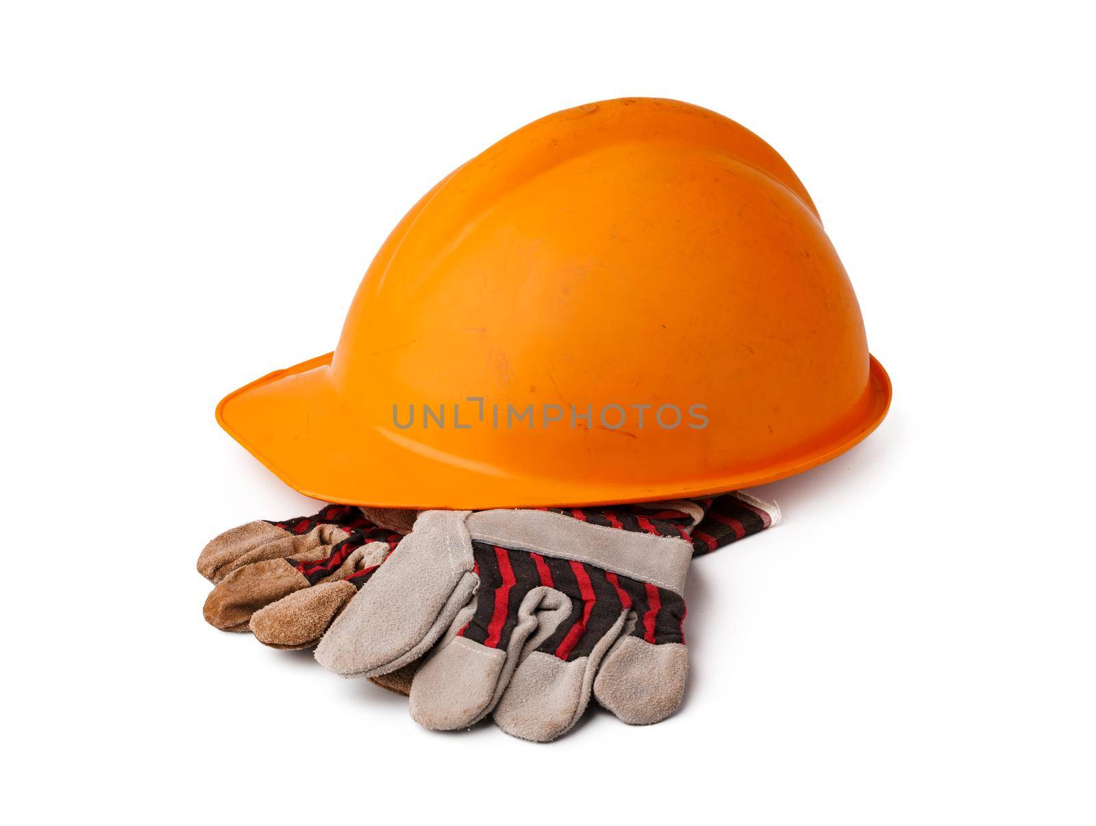 Safety hardhat and work gloves isolated on white background, close up