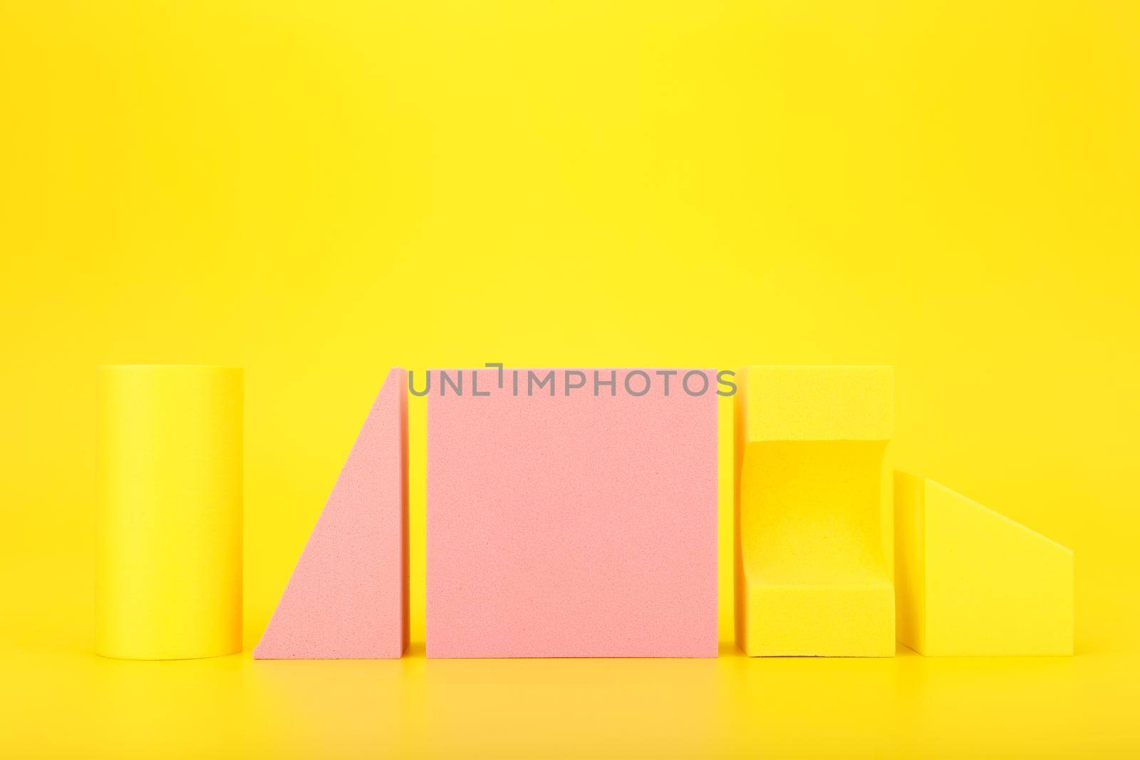 Abstract trendy futuristic background in yellow and pink colors with copy space. Bright artsy background with geometric shapes against yellow background with copy space