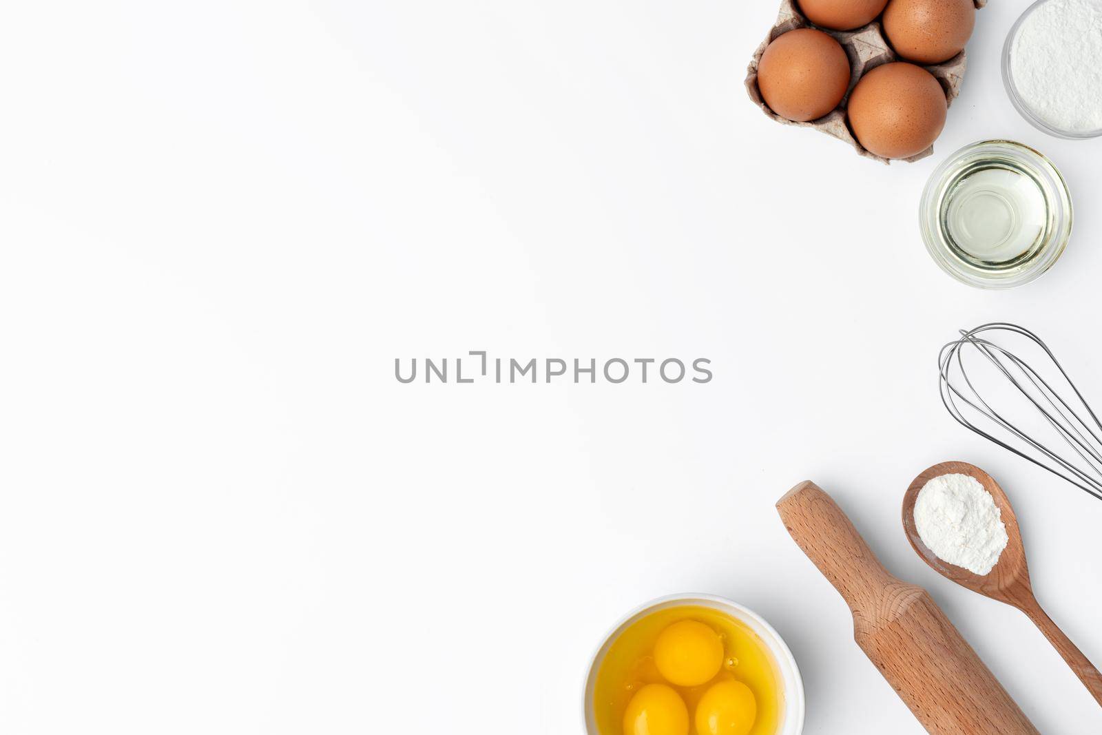 Metal whisk and eggs for cooking isolated on white background