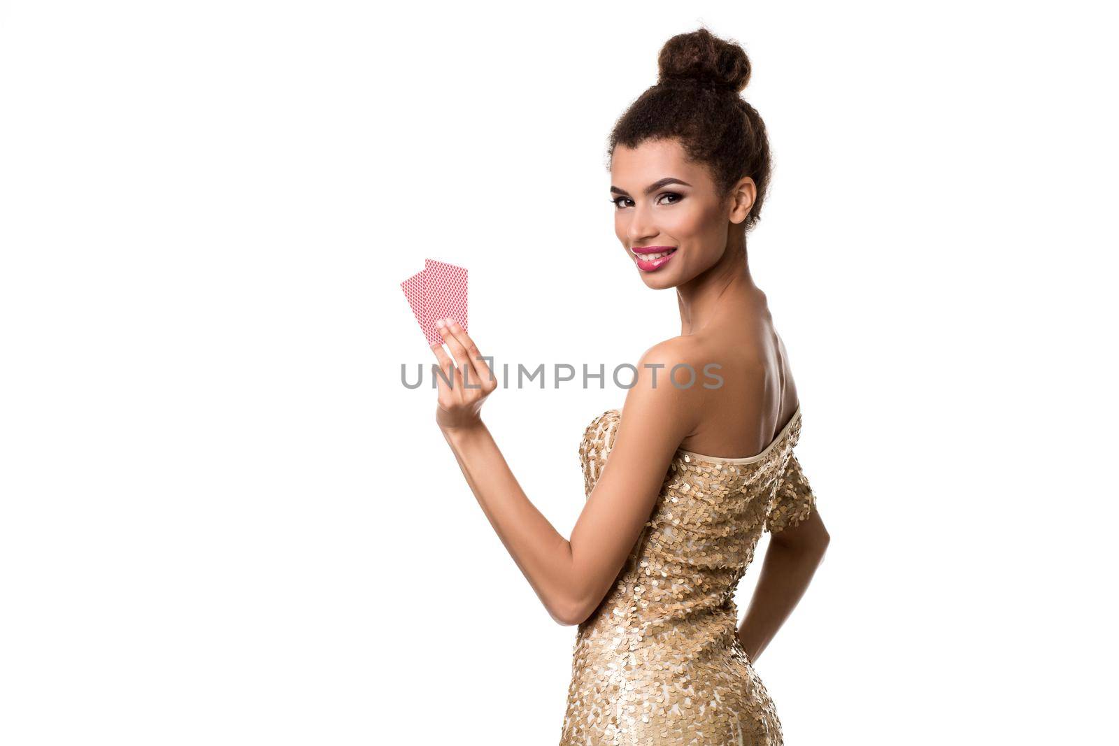 Pretty african girl shows two cards in casino poker and win Young woman in studio on white background