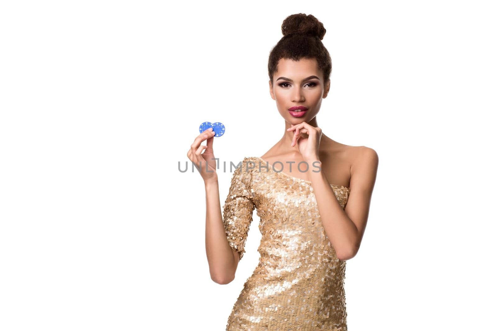 Smiling young woman holding two chips in her hands. Woman in gold dress is isolated on white background