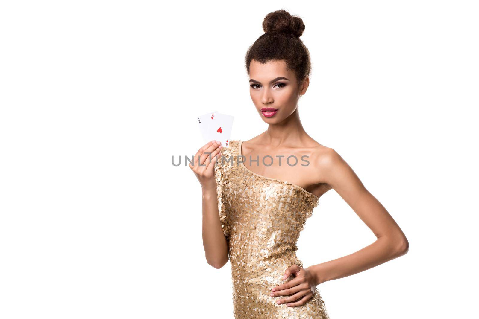 Beautiful young woman holding two ace of cards in her hand isolated on white. Studio shot. Poker