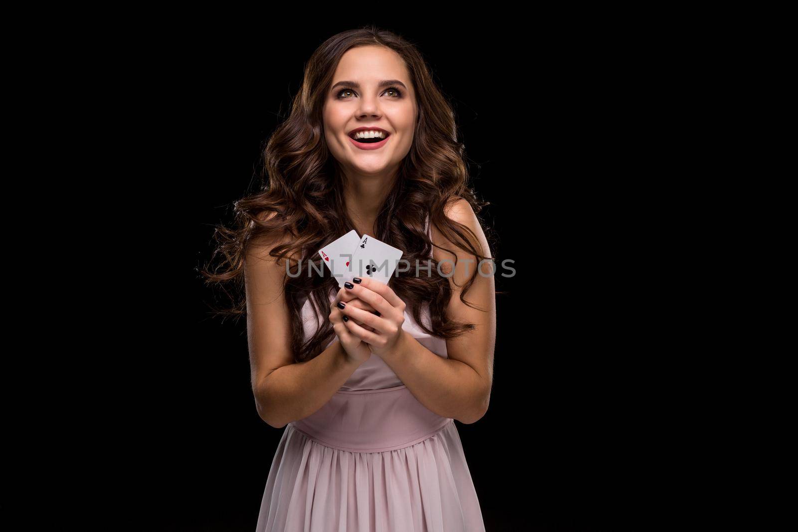 Attractive young woman holding the winning combination of poker cards by nazarovsergey