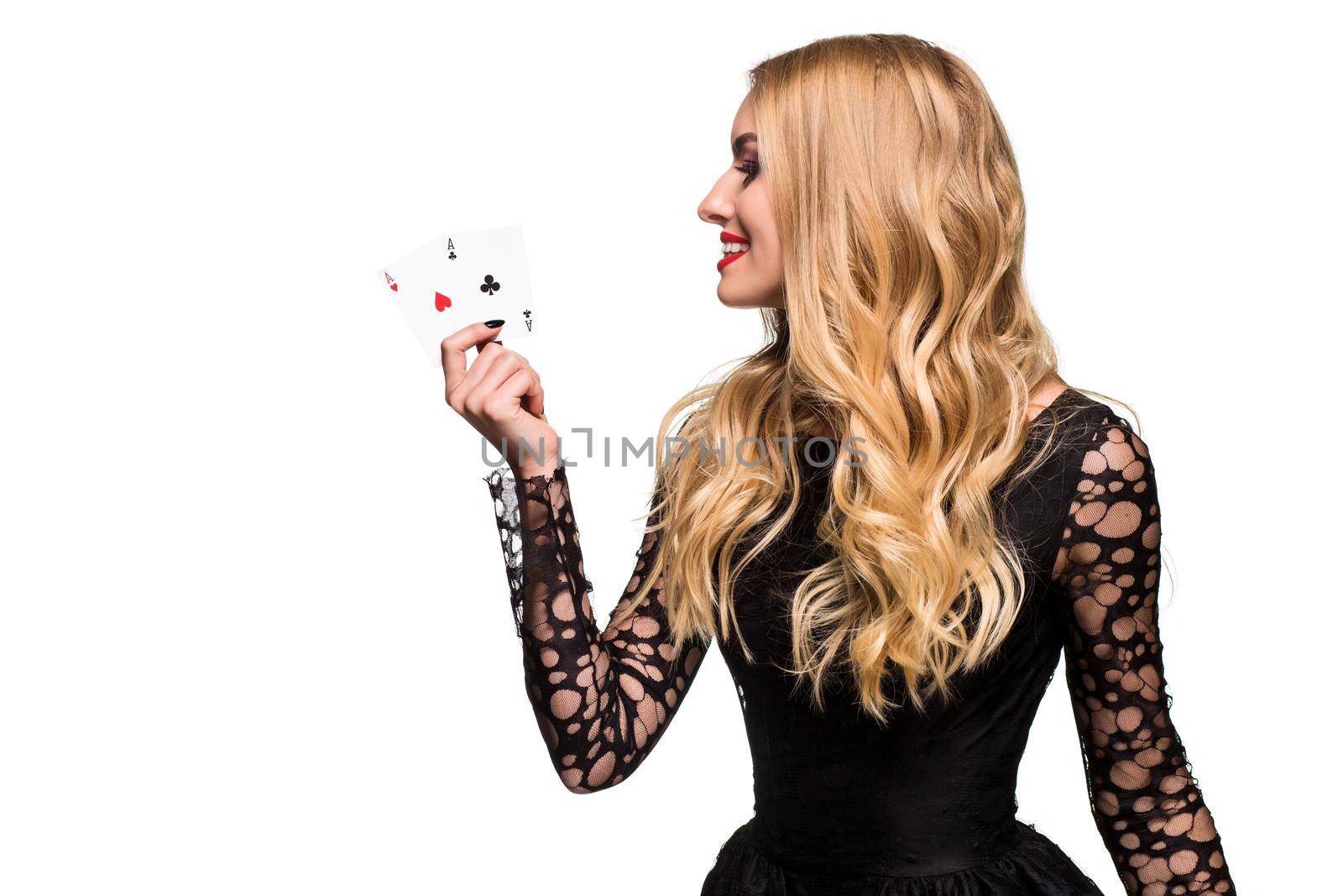 Beautiful young woman holding two ace of cards in her hand isolated on black background by nazarovsergey