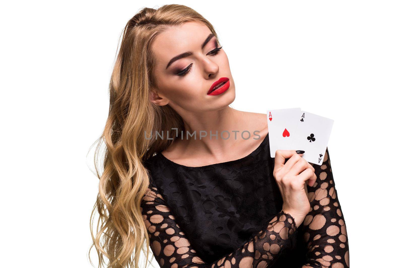 Beautiful blonde in a black dress with casino cards two aces in hands isolated on a white background. Poker. Casino. Roulette Blackjack Spin. Caucasian young woman looking at the camera. Winning combination