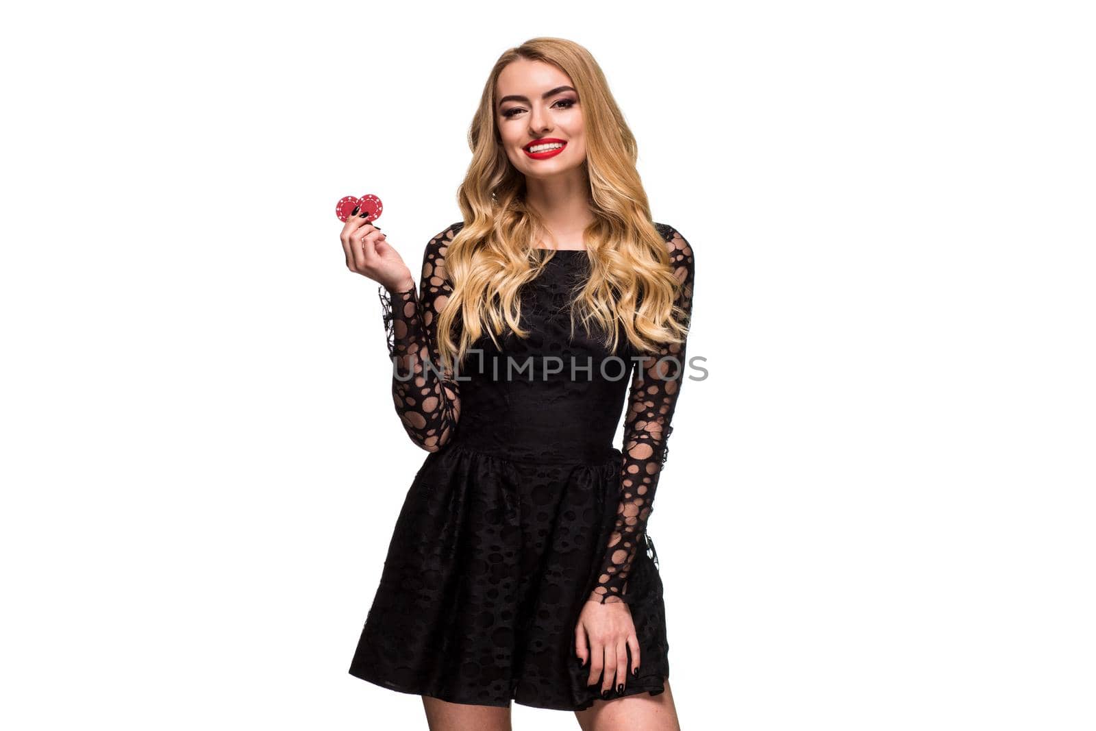 Beautiful blonde in a black dress with casino chips in hands isolated on a white background by nazarovsergey