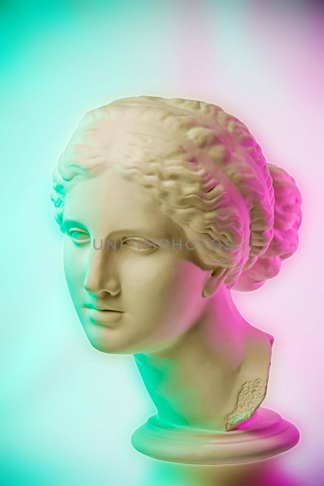 Statue of Venus de Milo. Creative concept colorful neon image with ancient greek sculpture Venus or Aphrodite head. Webpunk, vaporwave and surreal art style. Pink and green duotone effects. by bashta