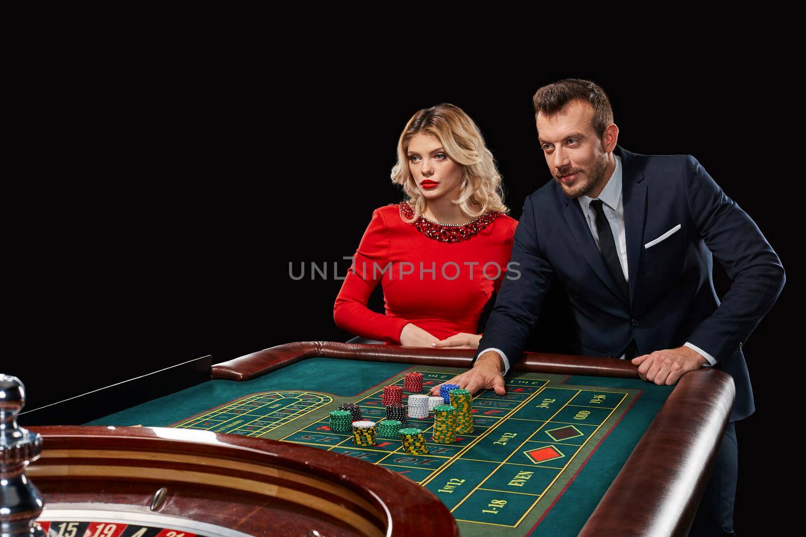 Couple playing roulette wins at the casino. Addiction to the gambling. he bets chips