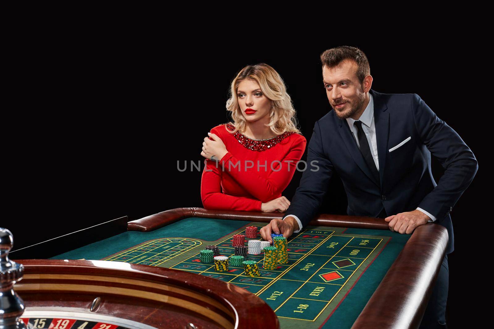 Couple playing roulette wins at the casino. Addiction to the gambling. he bets chips