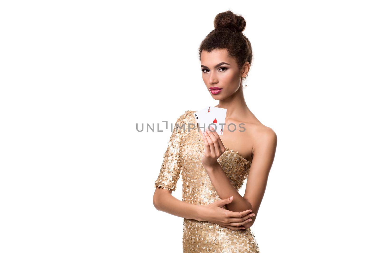 Beautiful young woman holding two ace of cards in her hand isolated on white. Studio shot. Poker