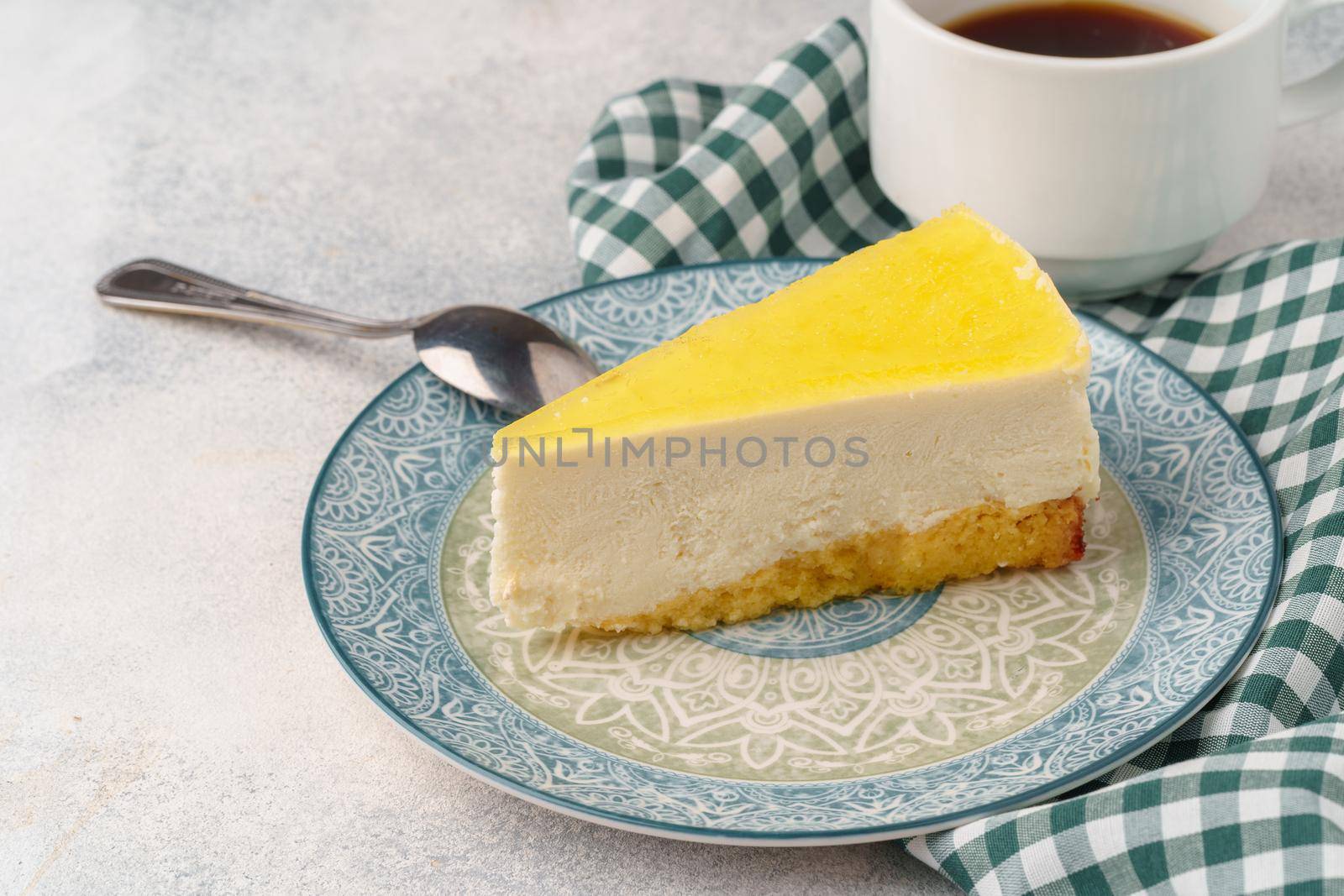 Lemon cheesecake on the plate close up photo
