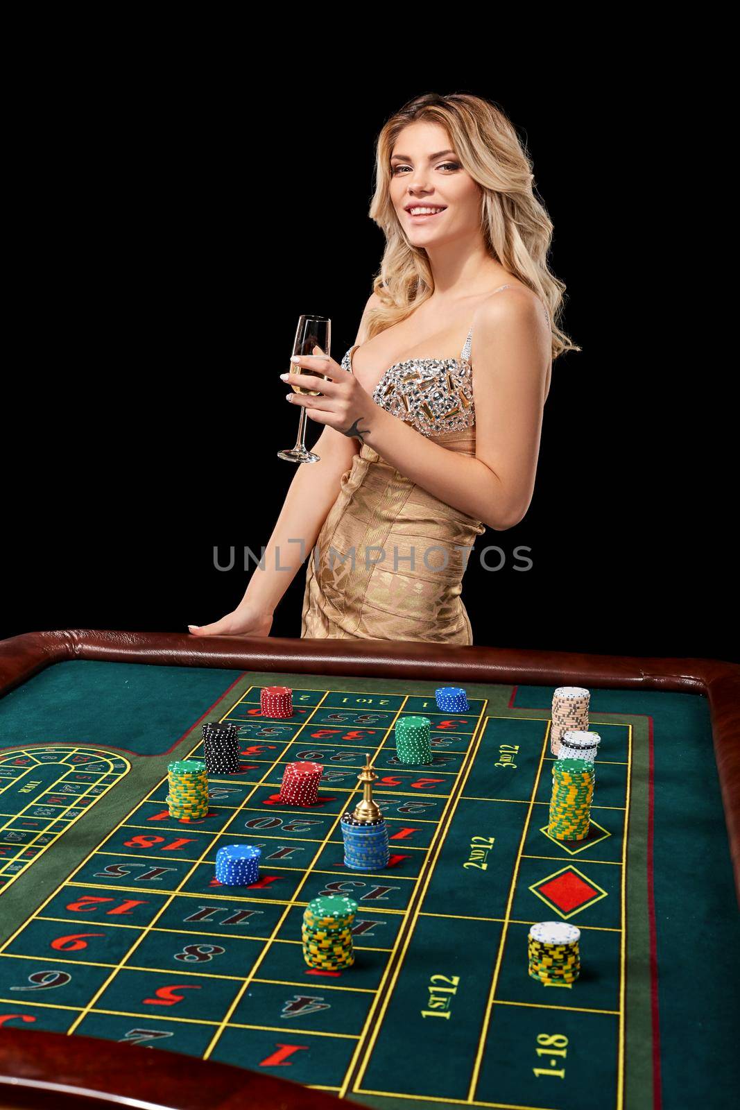 woman in a smart dress plays roulette. addiction to gambling. holding hands in a glass