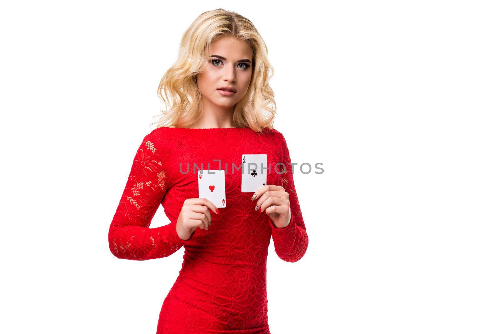 Caucasian young woman with long light blonde hair in evening outfit holding playing cards. Isolated on white background. Poker