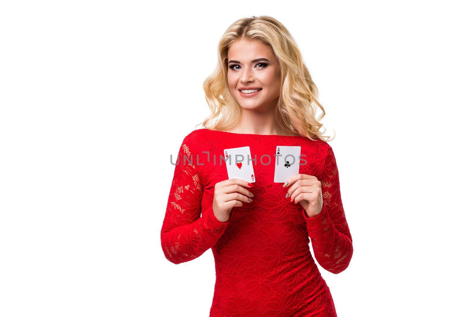 Caucasian young woman with long light blonde hair in evening outfit holding playing cards. Isolated on white background. Poker