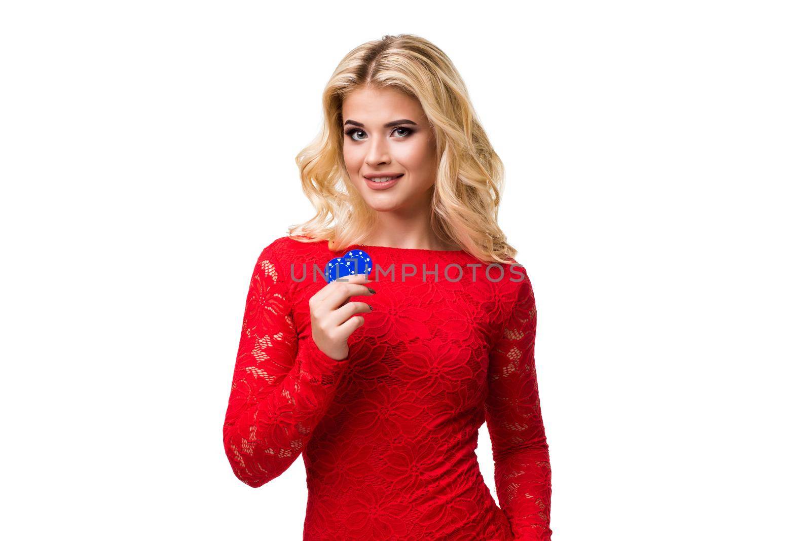 Caucasian young woman with long light blonde hair in evening outfit holding playing chips. Isolated on white background. Poker