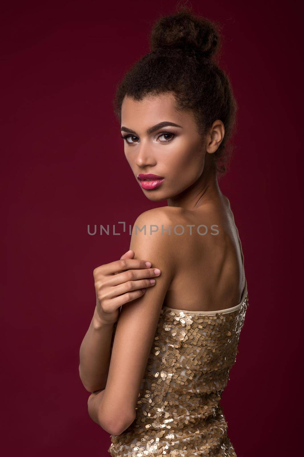 Fashion young African woman with make-up, in sexy gold dress. by nazarovsergey