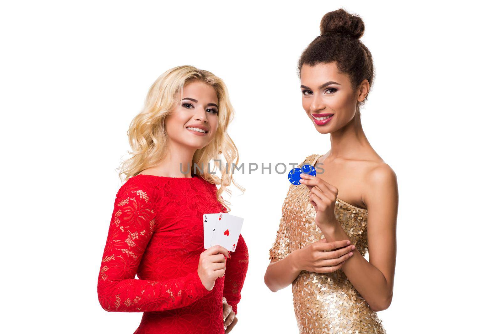 Beautiful african woman and Caucasian young woman with long light blonde hair in evening outfit. Holding playing cards and chips. Isolated. Poker by nazarovsergey