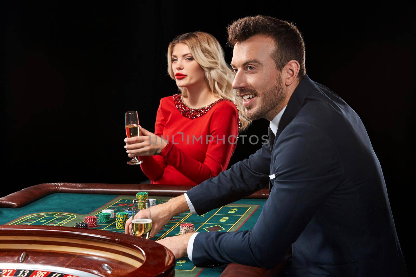 Couple playing roulette wins at the casino. Addiction to the gambling