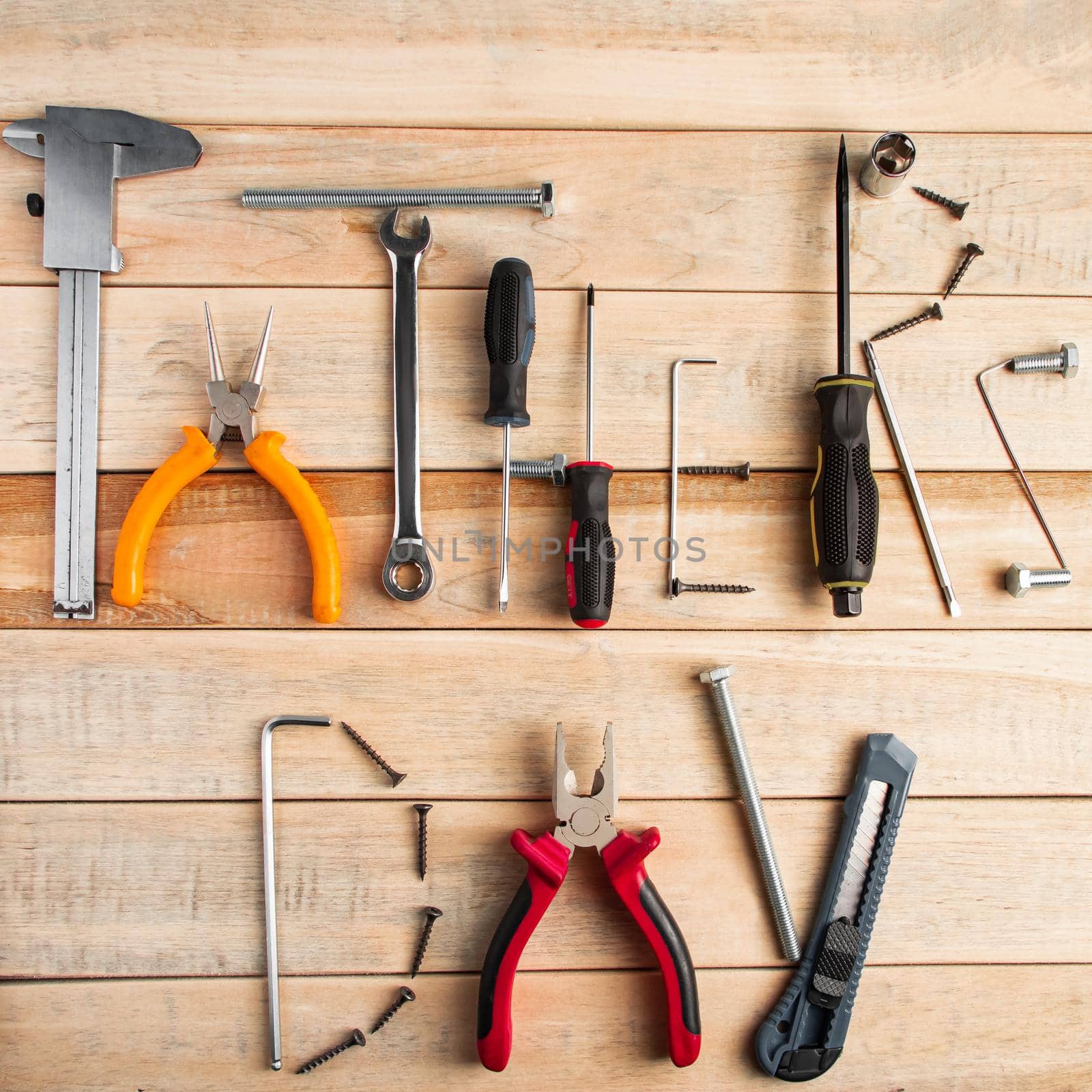 Set of work tools on a wooden background. Festive greeting card concept for Father's day. by Statuska