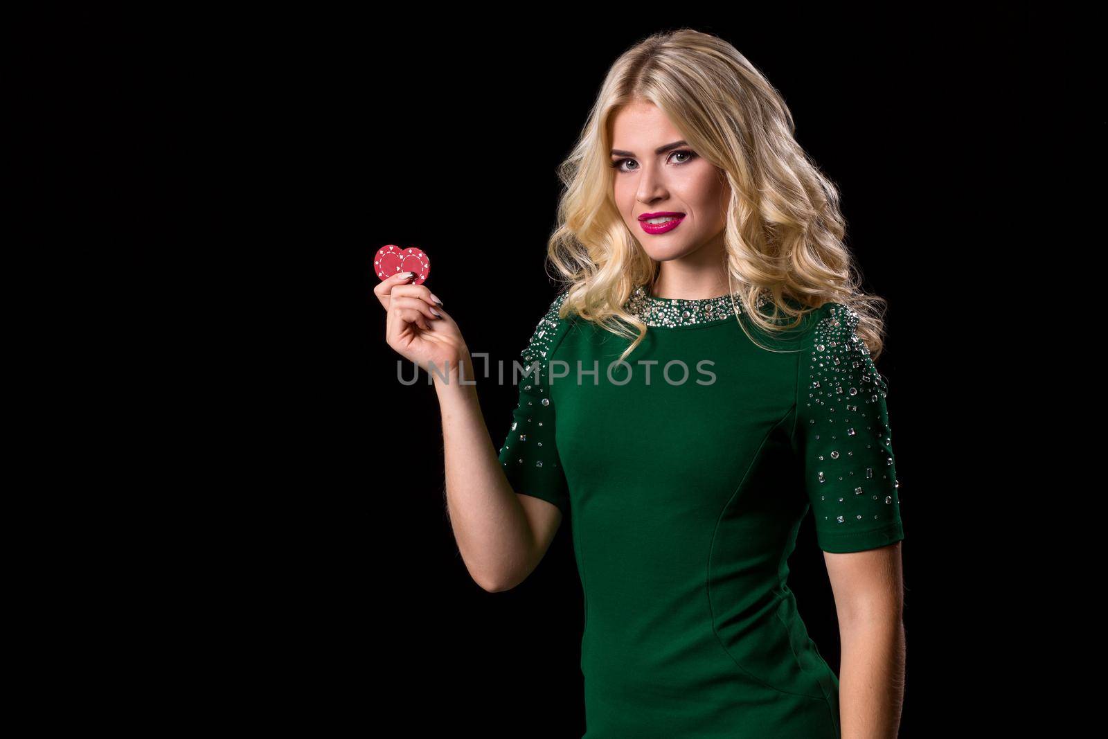 blonde woman posing with chips for gambling on black background