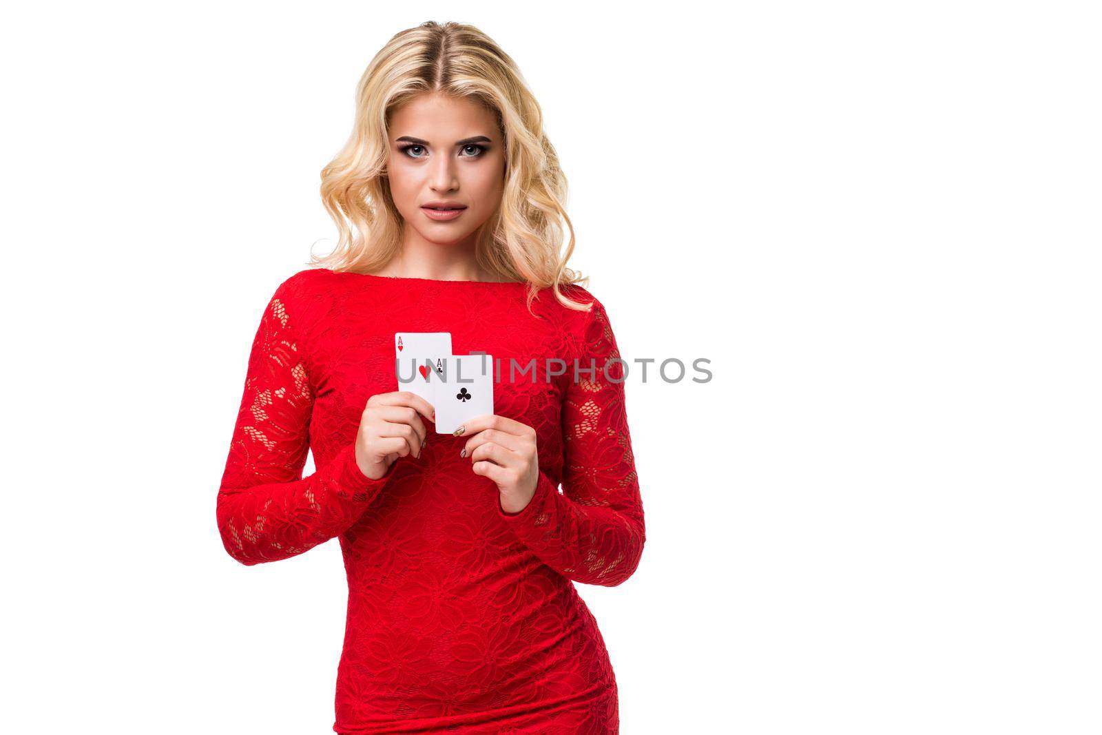 Caucasian young woman with long light blonde hair in evening outfit holding playing cards. Isolated on white background. Poker