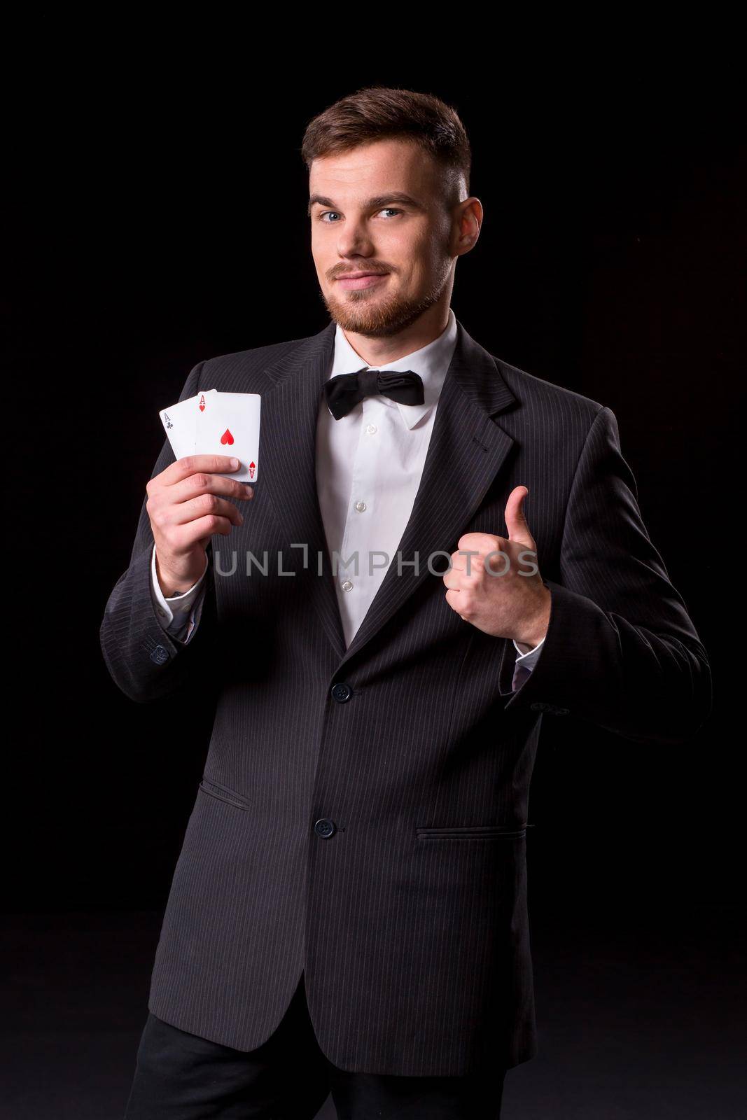 man in a suit posing with cards by nazarovsergey
