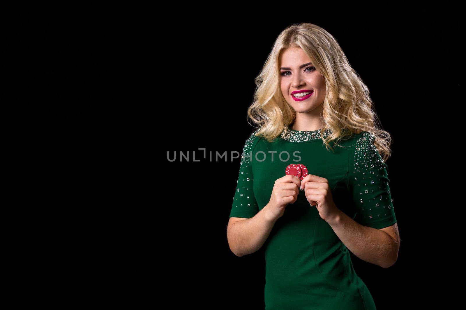 blonde woman posing with chips for gambling on black background