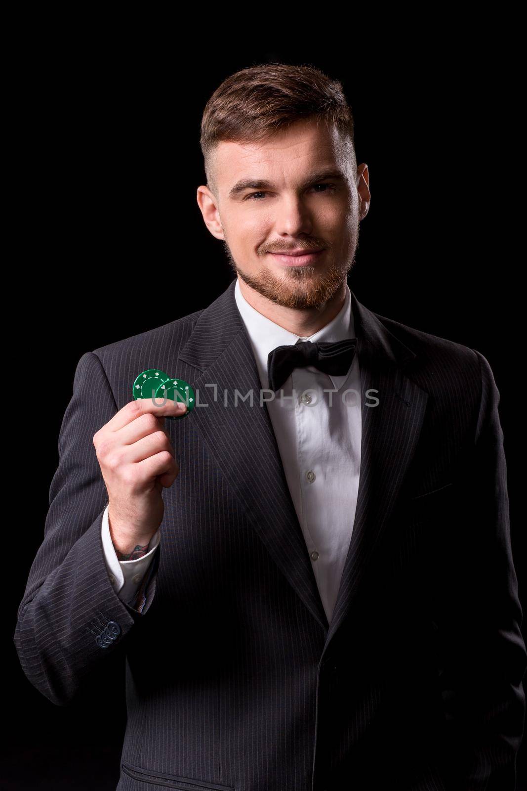 man in a suit posing with chips for gambling by nazarovsergey