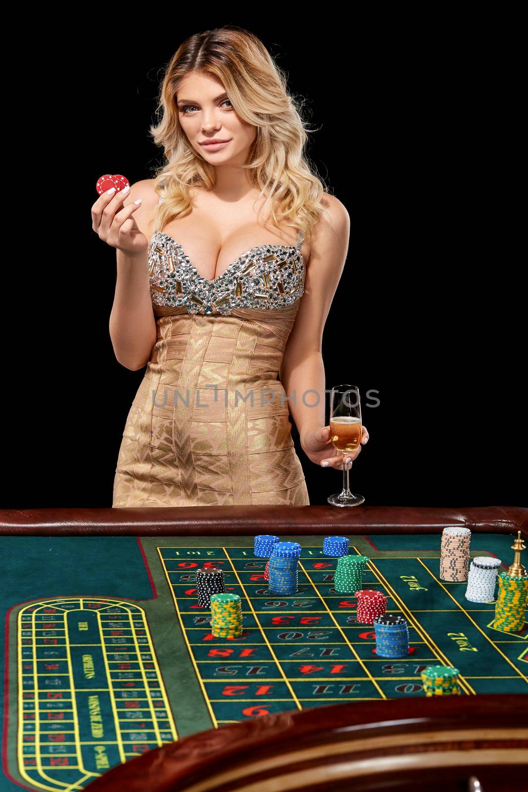 woman in a smart dress plays roulette. addiction to gambling. holding in the hands of chips