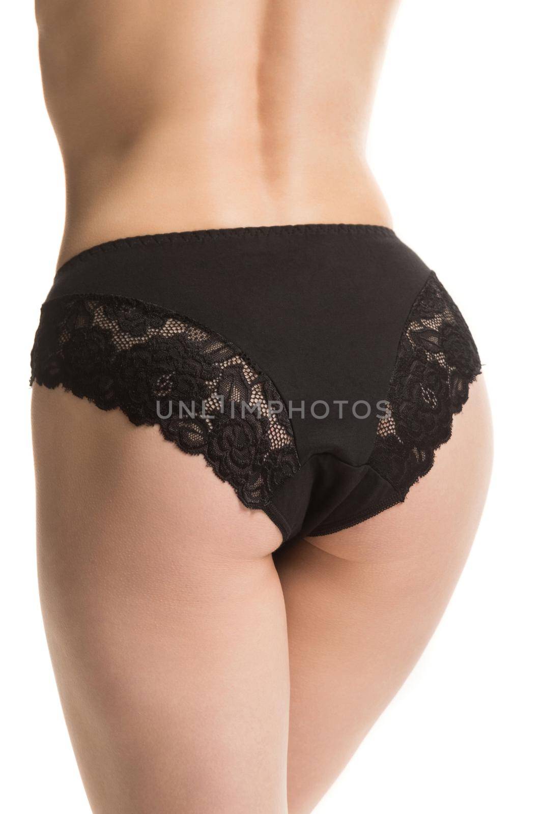 girl in black lace panties, back view, half-length shot on a white background by TRMK