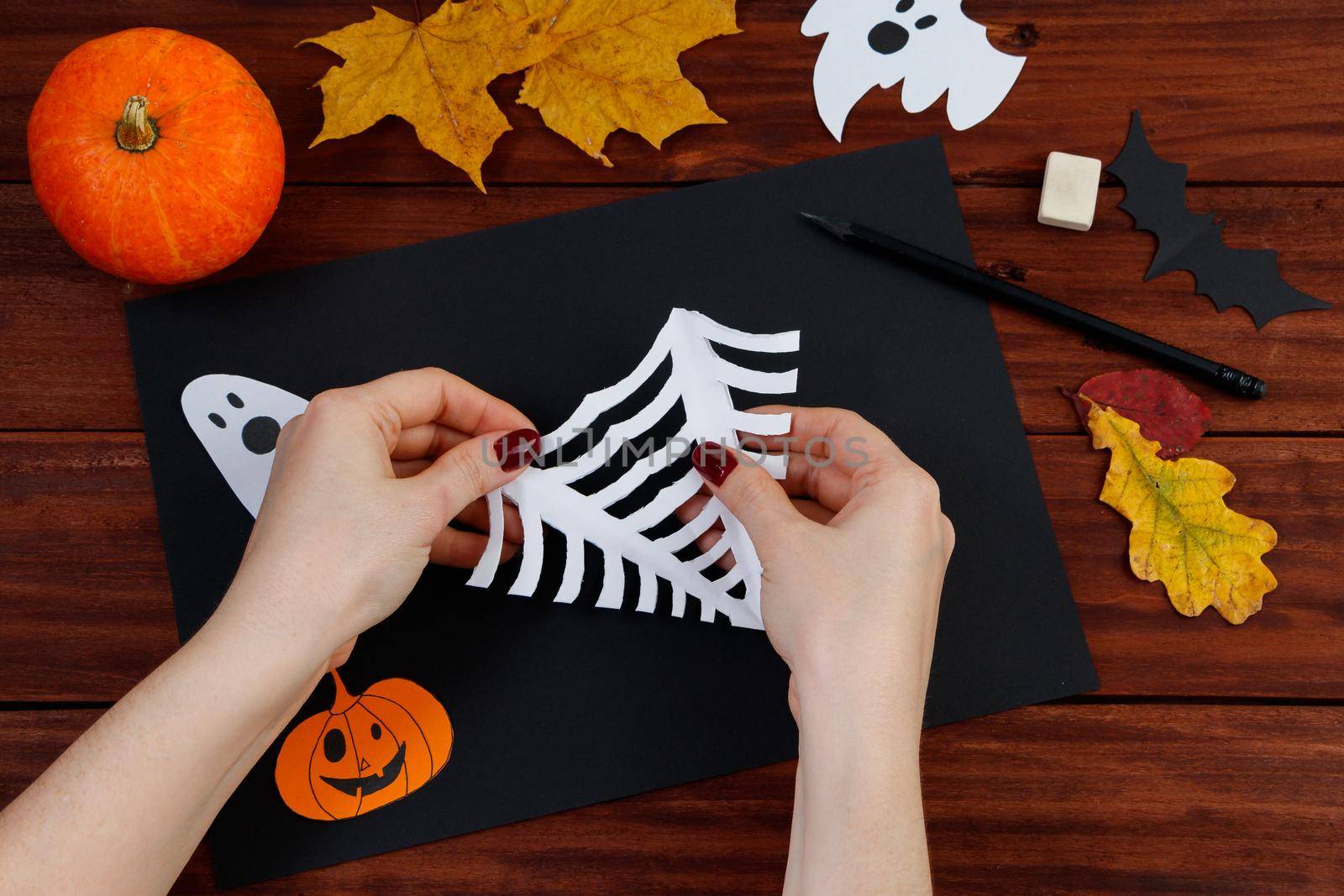 Halloween DIY. Step-by-step instructions for cutting a spider web from paper for the holiday. Step 9.