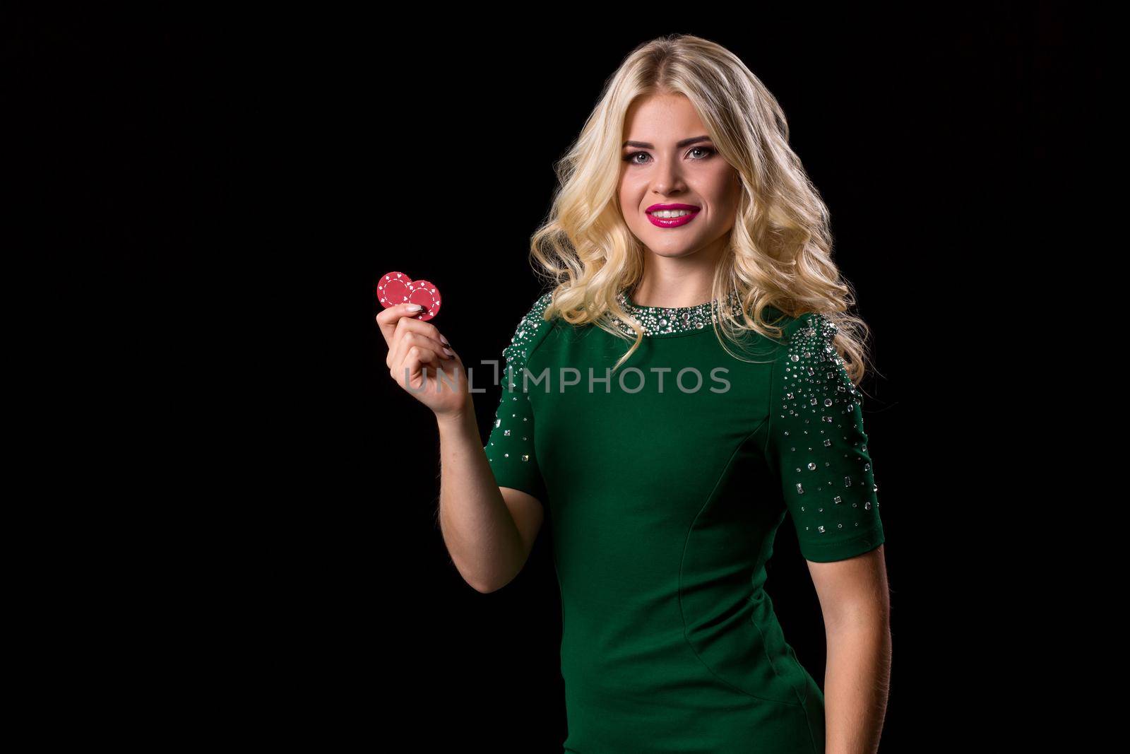 blonde woman posing with chips for gambling on black background