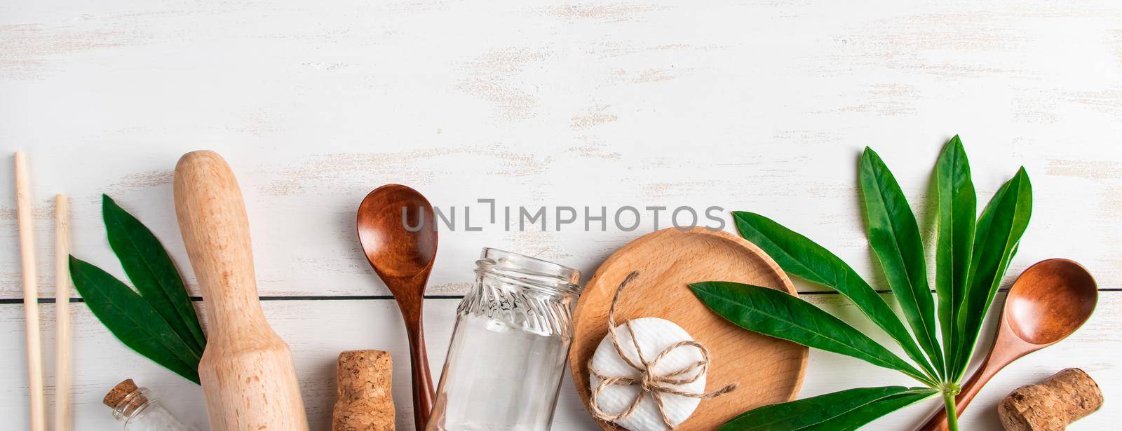 Eco-friendly recyclable products on white wooden background. Plastic-free kitchen accessories. by Statuska