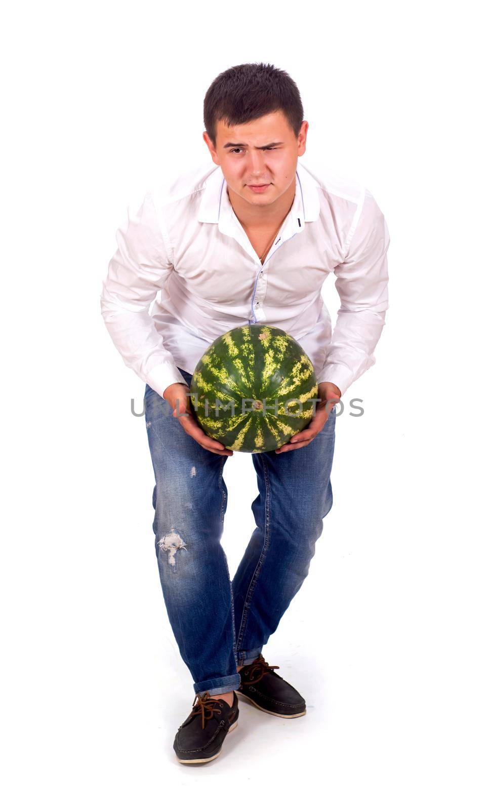 man in white shirt and jeans drags big watermelon isolated on white background by aprilphoto
