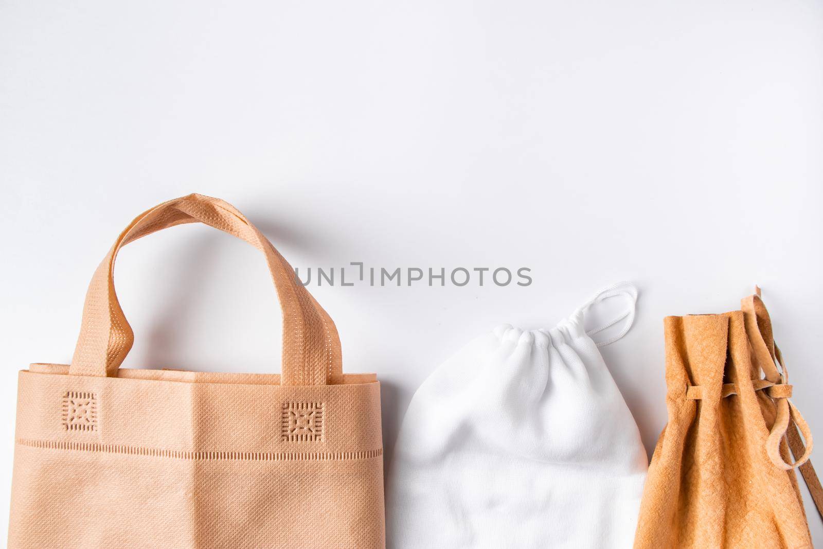 Zero waste concept. Set recycled home accessories - eco-friendly bags and wooden supplies by Statuska