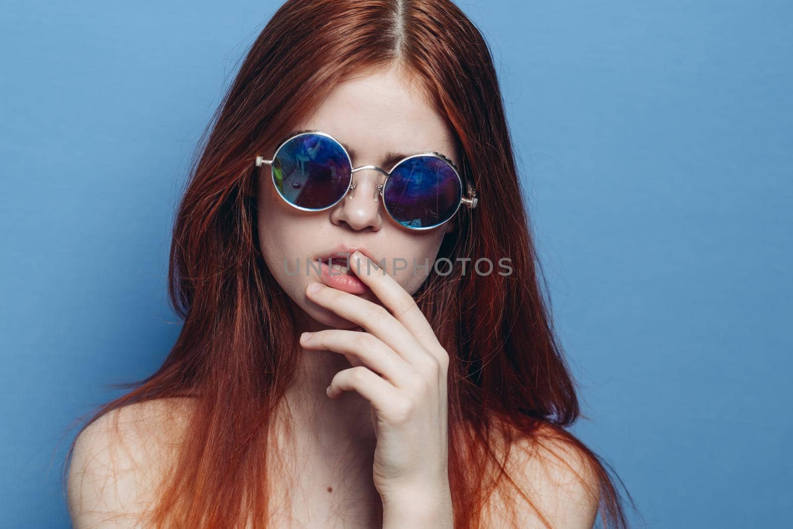 attractive woman with bare shoulders fashionable glasses blue background by Vichizh