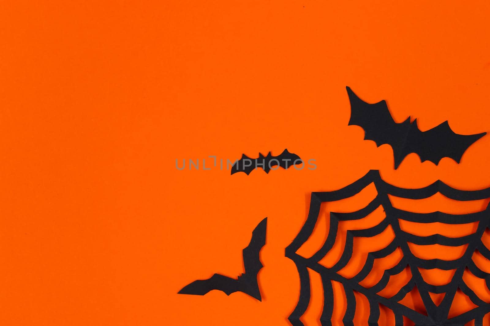 Halloween concept. Festive decorations. Bats on an orange background.