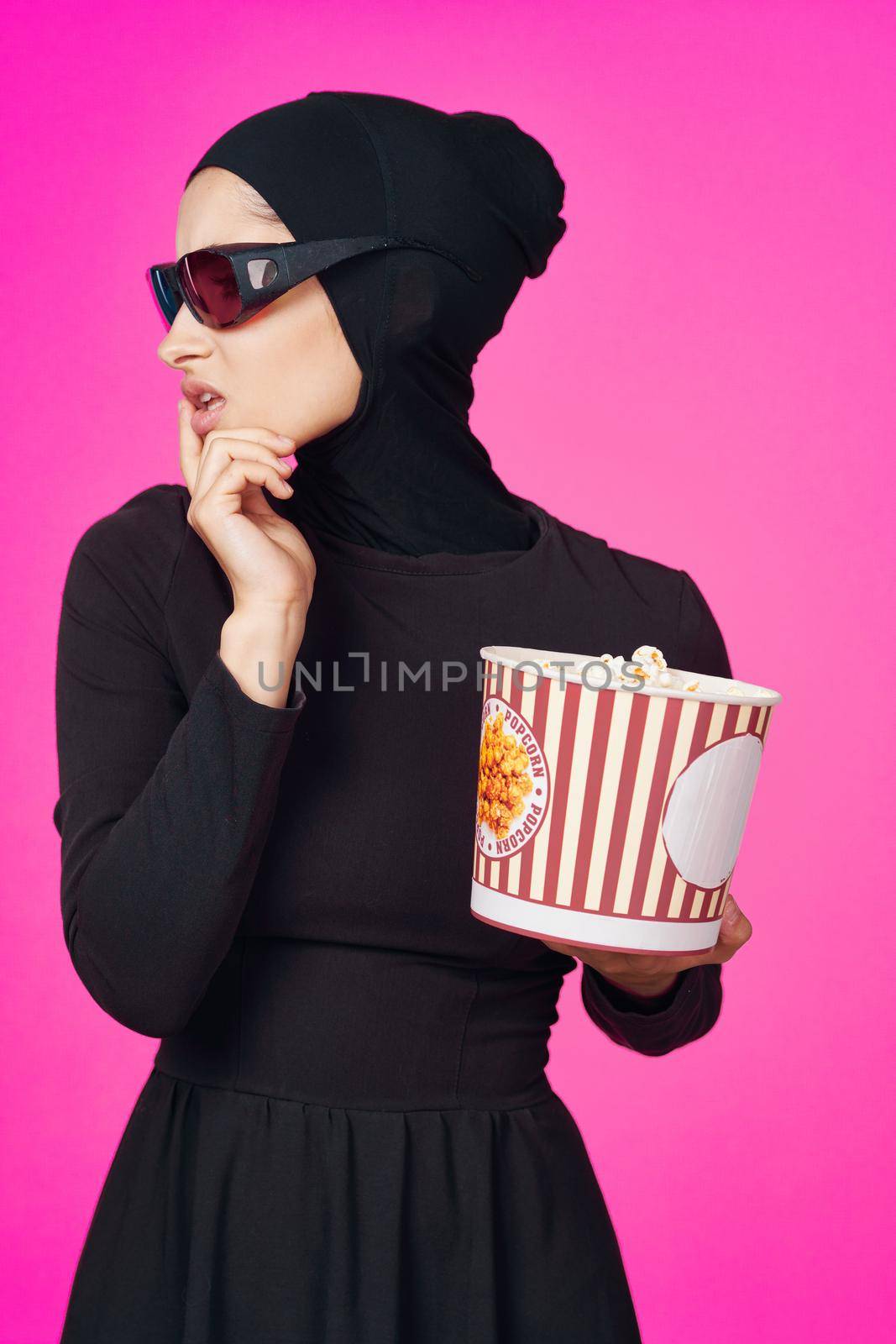 Muslim woman attractive look popcorn glasses movie watching isolated background. High quality photo