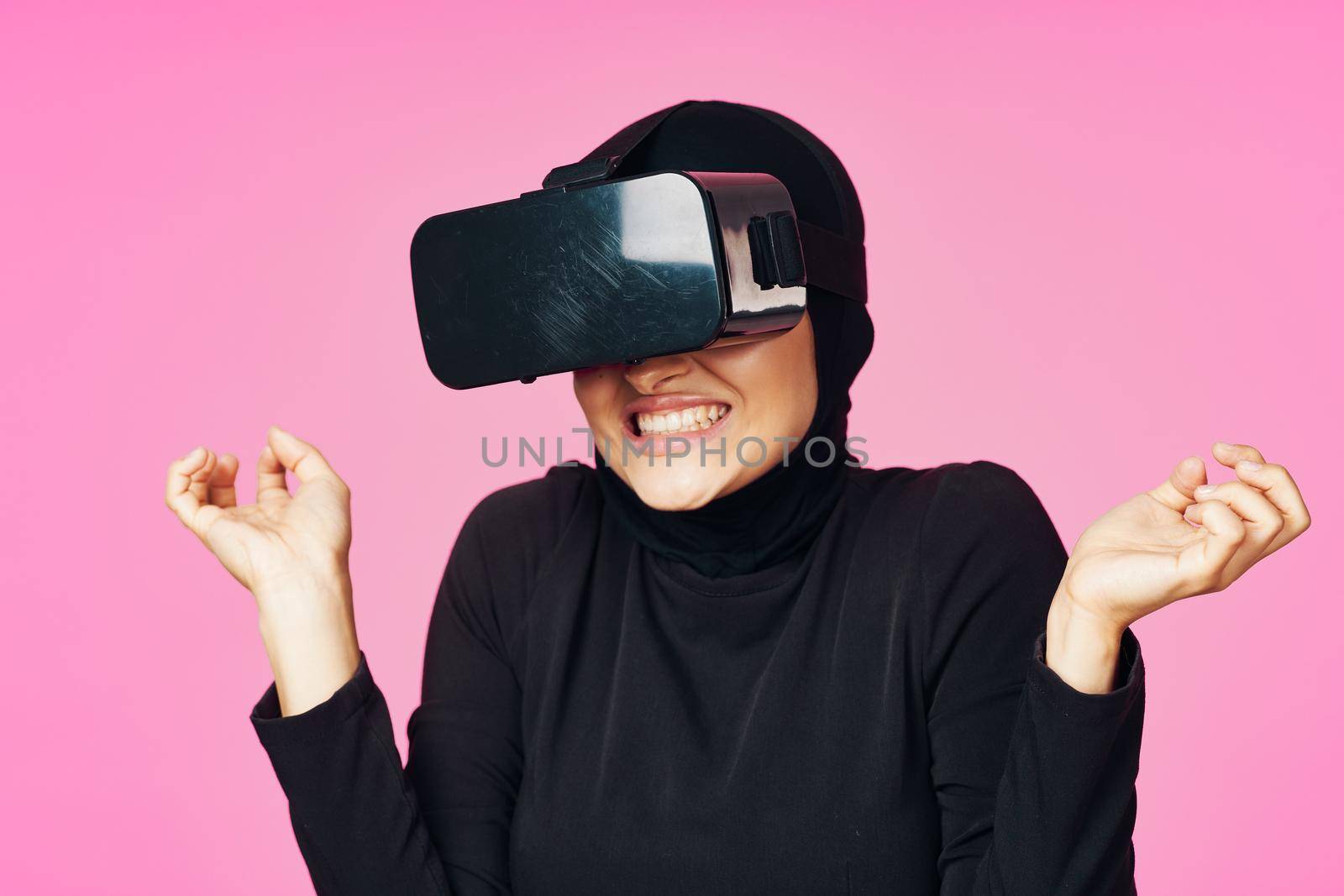muslim woman wearing virtual reality glasses entertainment technology device. High quality photo