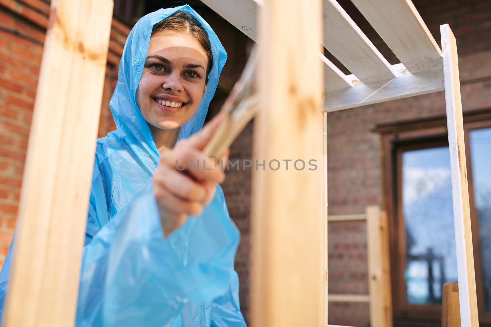 woman painter painting wood home renovation texture. High quality photo