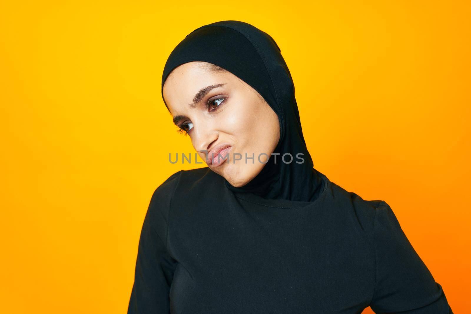 cheerful woman in black hijab posing fashion hand gesture studio lifestyle by Vichizh