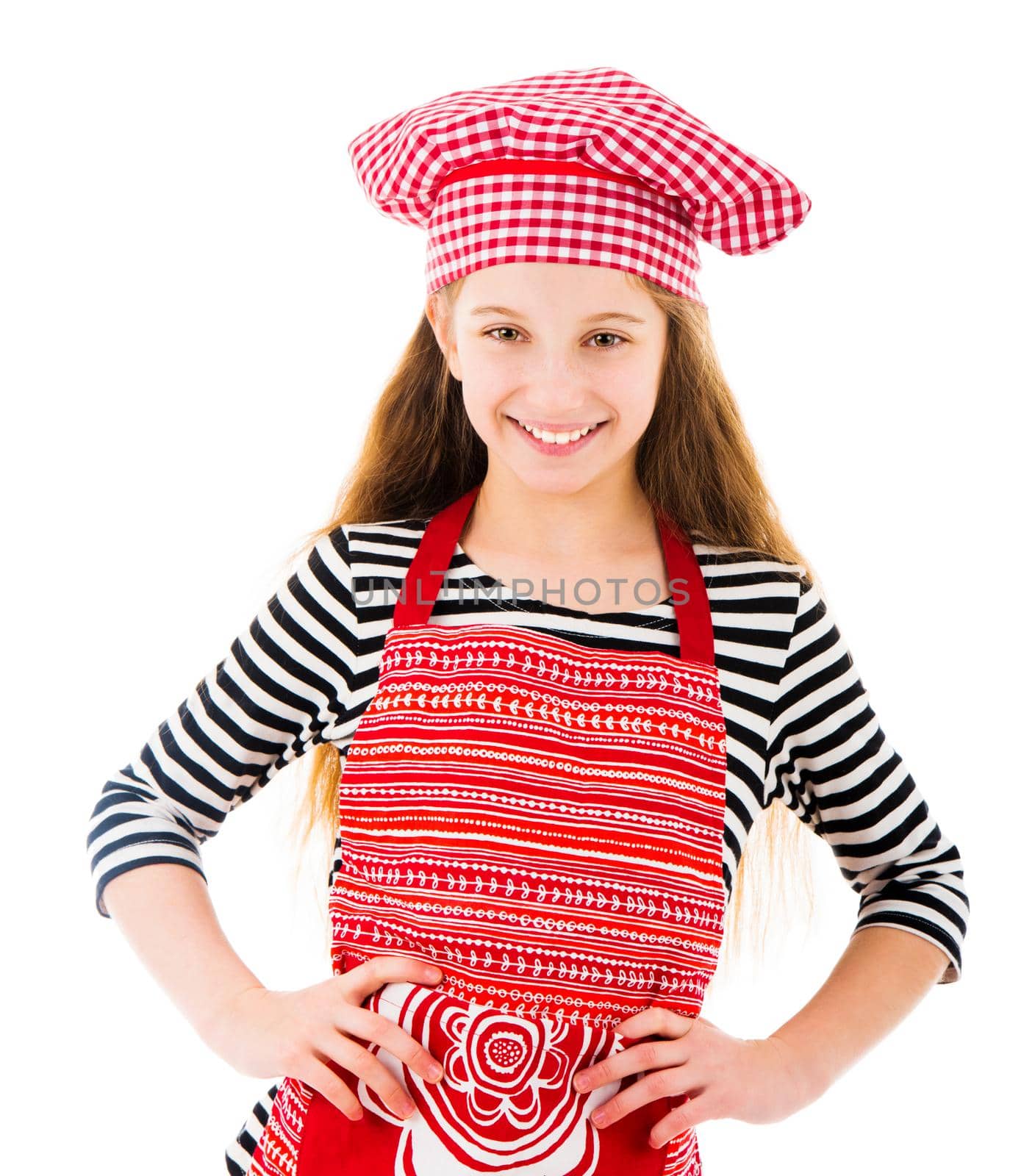 Little girl in red chef uniform smiles isolated on white background